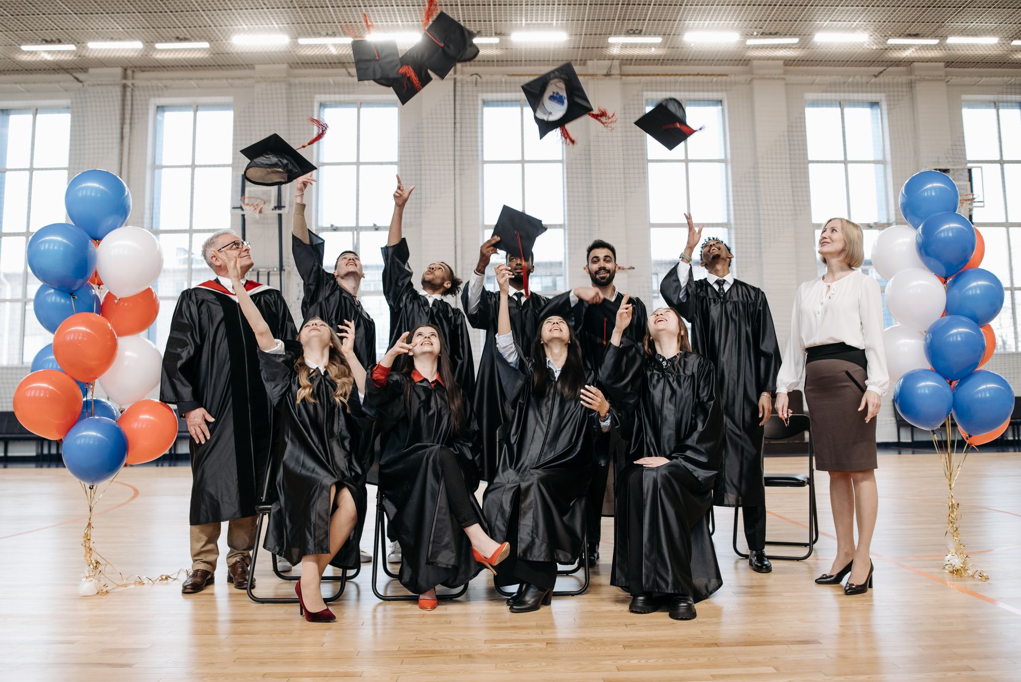 Graduates celebrating their success, throwing their caps in the air